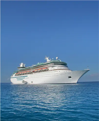 Large white cruise ship on calm blue ocean under clear sky.