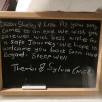 Thank you and save travels note written on a chalkboard